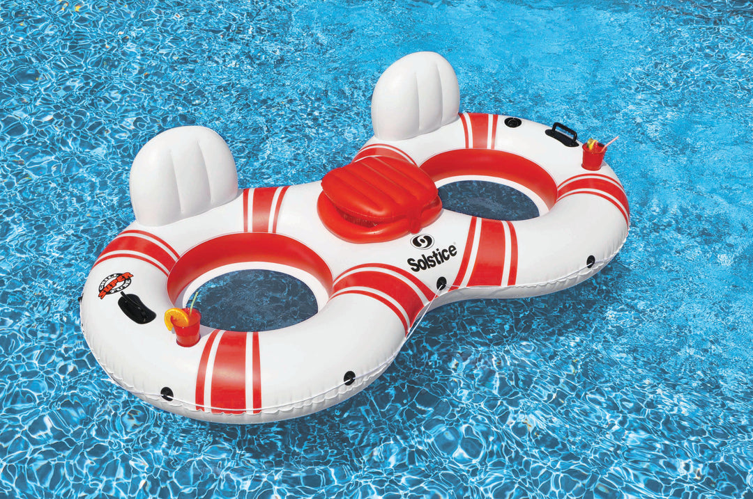 White and red double circular inflatable pool float with backrests and built-in cooler floating in clear blue water