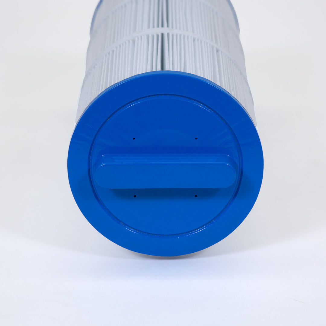 Close-up of a replacement filter cartridge end with a blue plastic cap and pleated white filter material extending from it