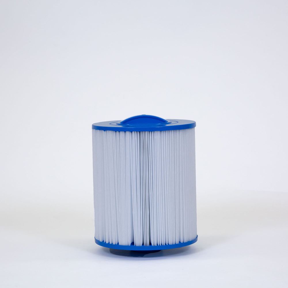 cylindrical replacement filter cartridge with blue plastic ends and white pleated filter material standing upright on white surface