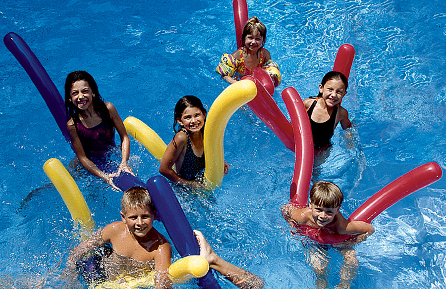 children playing in a pool holding colorful inflatable Swimline 72 inch pool noodles in red, yellow, and blue floating on water