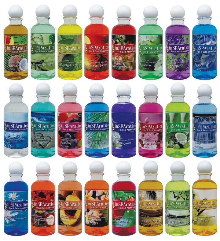 row of 25 inSPAration 9oz oil-free aromatherapy liquid bottles in various colors including green, yellow, red, blue, and purple with round white caps and tropical fruit and flower label images