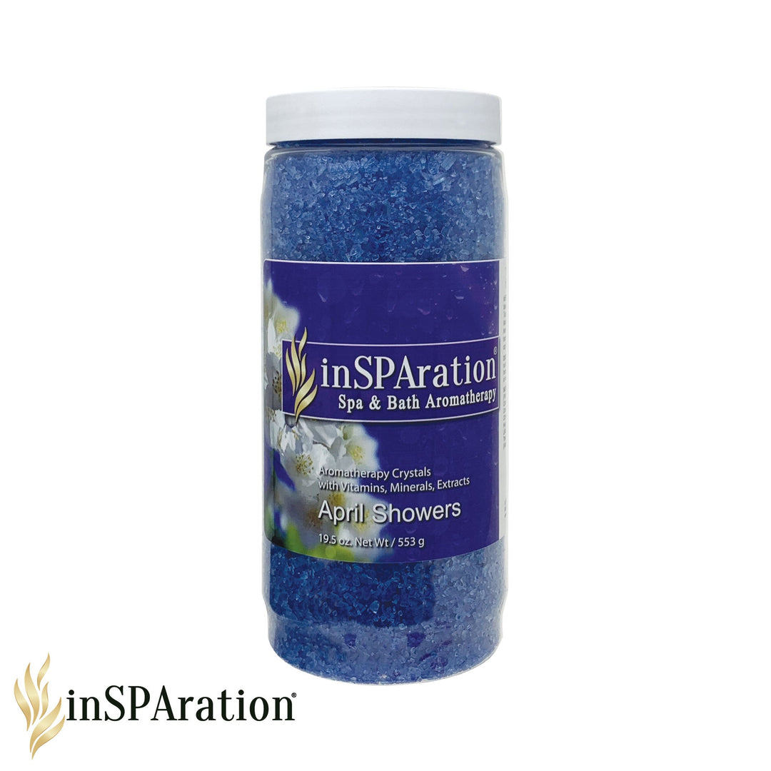 InSPAiration April Showers aromatherapy crystals in a clear plastic jar with blue crystals and purple label featuring white flowers and gold logo
