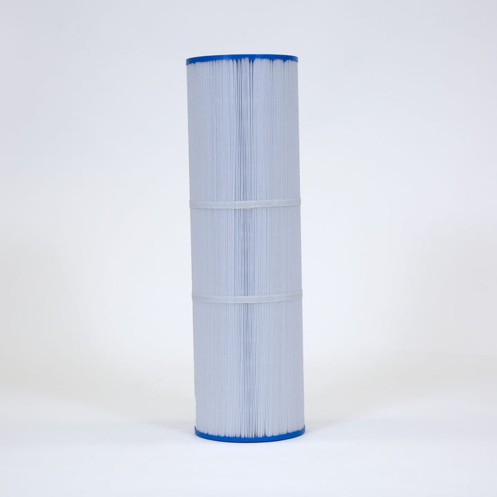 Tall cylindrical replacement filter cartridge with pleated white material and blue flat end caps standing upright on white surface