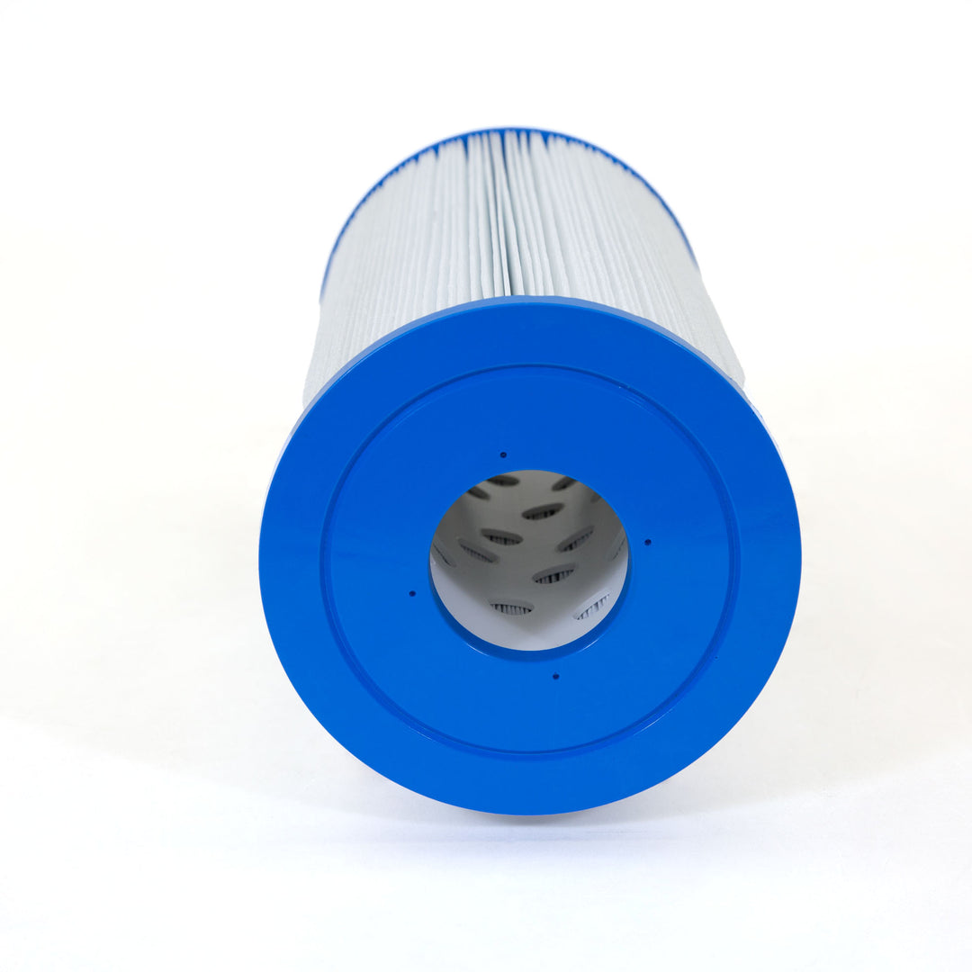 cylindrical replacement filter cartridge with white pleated material and blue plastic end caps lying on a white surface