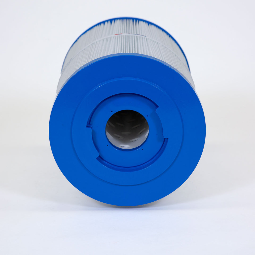 cylindrical spa filter cartridge with blue end caps and pleated white filtering material resting horizontally