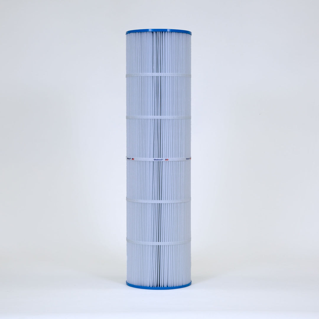 tall cylindrical pool filter cartridge with white pleated material and blue top and bottom edges standing upright on plain background