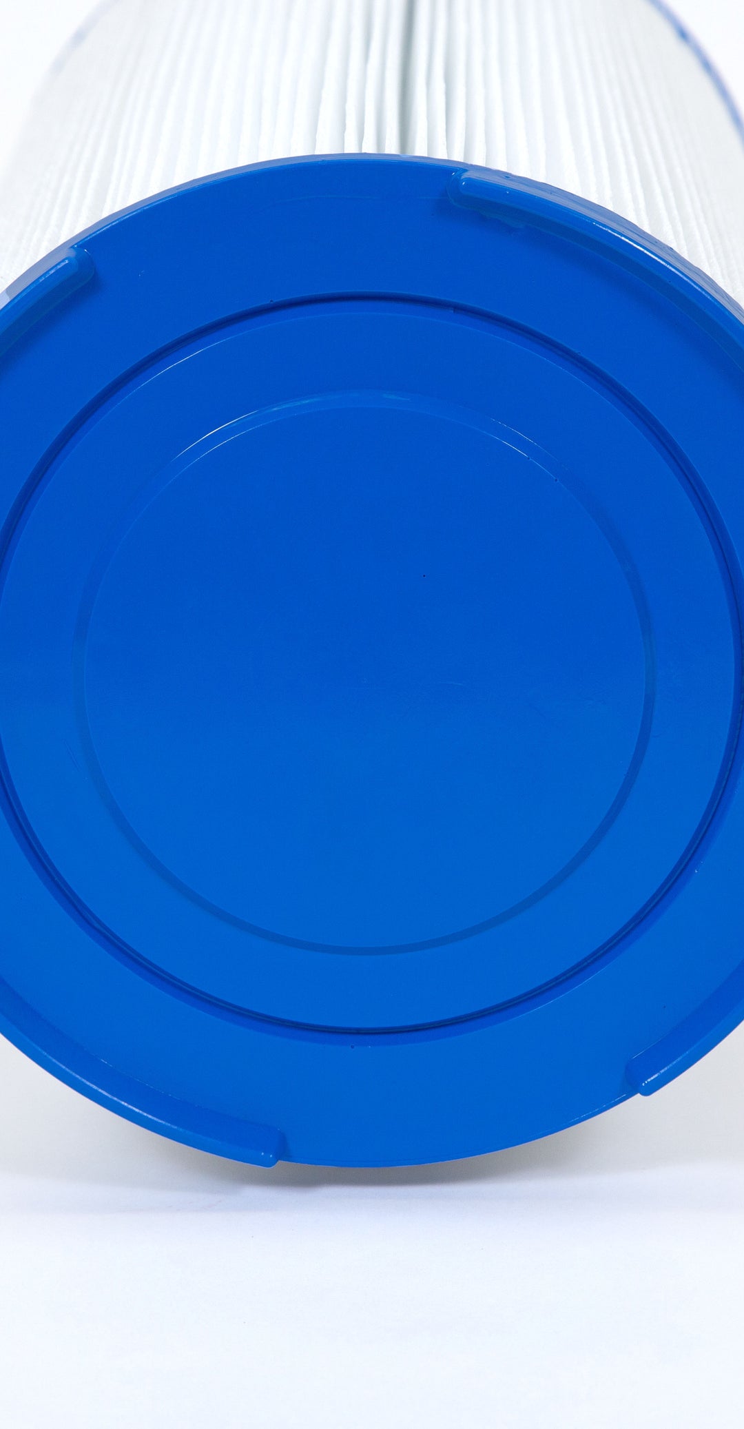 Close-up view of a cylindrical white pleated filter cartridge with a blue plastic end cap on a white background