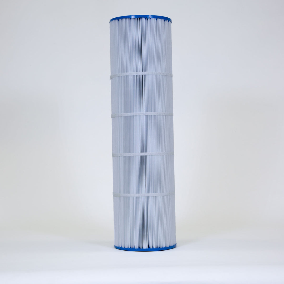 Tall cylindrical pool filter cartridge with white pleated fabric and blue plastic ends standing upright on a plain white surface