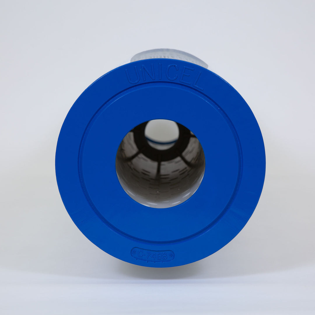 cylindrical pool filter cartridge with blue plastic end caps and pleated white filtering material inside shown from the top view