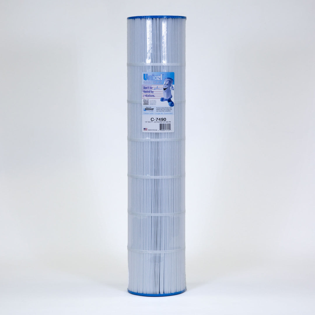 Tall cylindrical pool filter cartridge with white pleated material and blue caps on top and bottom against a plain background