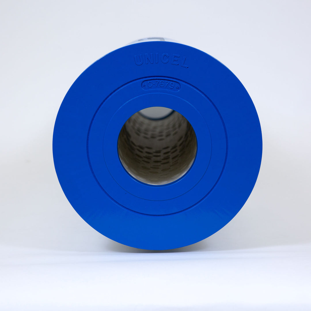 cylindrical blue filter cartridge standing upright on white surface with Unicel and C-7679 markings visible