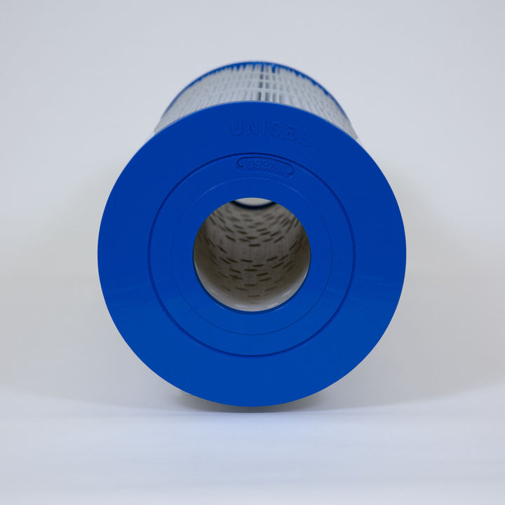 cylindrical pool filter cartridge with blue plastic end caps and white pleated filter material on a plain background
