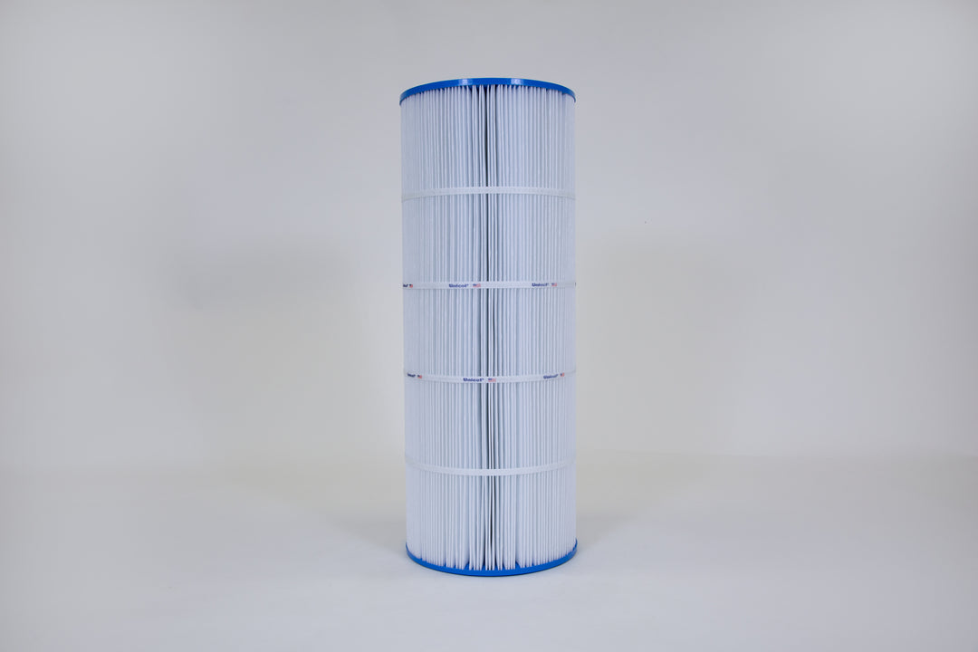 Tall cylindrical pool filter cartridge with pleated white material and blue plastic end caps standing against a plain light background