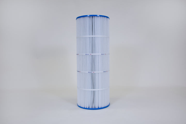 Tall cylindrical pool filter cartridge with pleated white material and blue plastic end caps standing against a plain light background