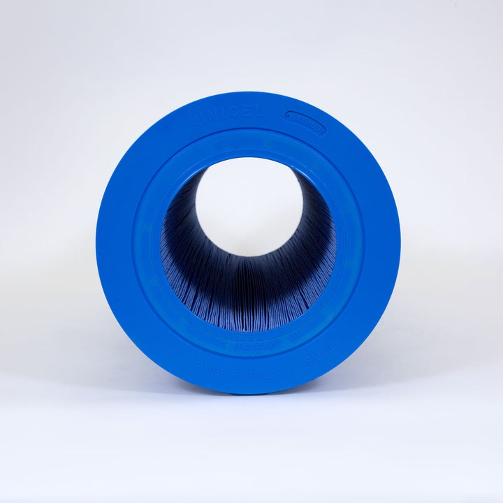 Blue cylindrical pool filter cartridge with pleated inner material and blue plastic end caps on white background