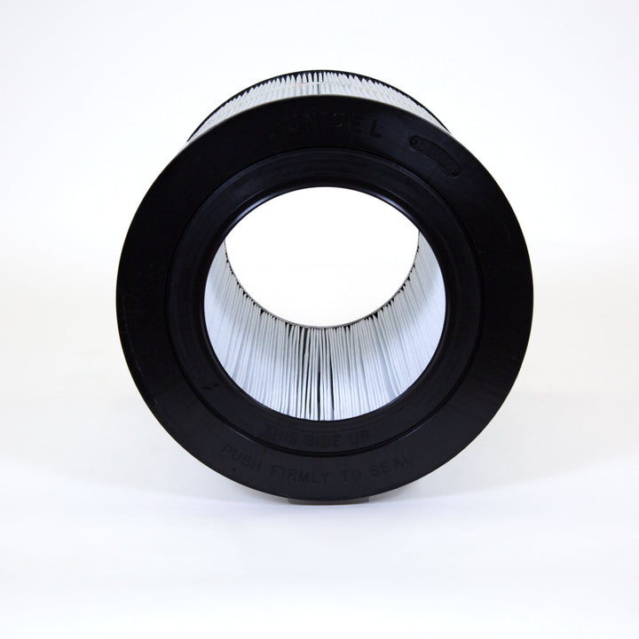 cylindrical pool or spa filter cartridge with pleated white filter material and black rubber ends photographed against white background