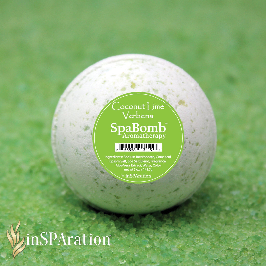 white spherical inSPAration SpaBomb aromatherapy bath bomb with green speckles and green label on green bath salts background