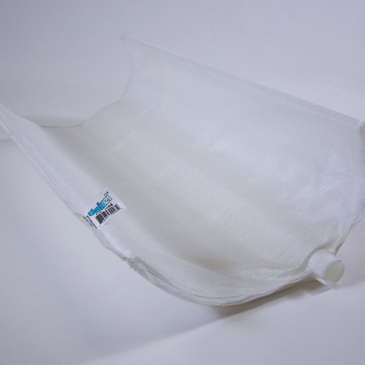White replacement DE filter grid with a plastic connector and a Unicel branded label lying on a plain light surface