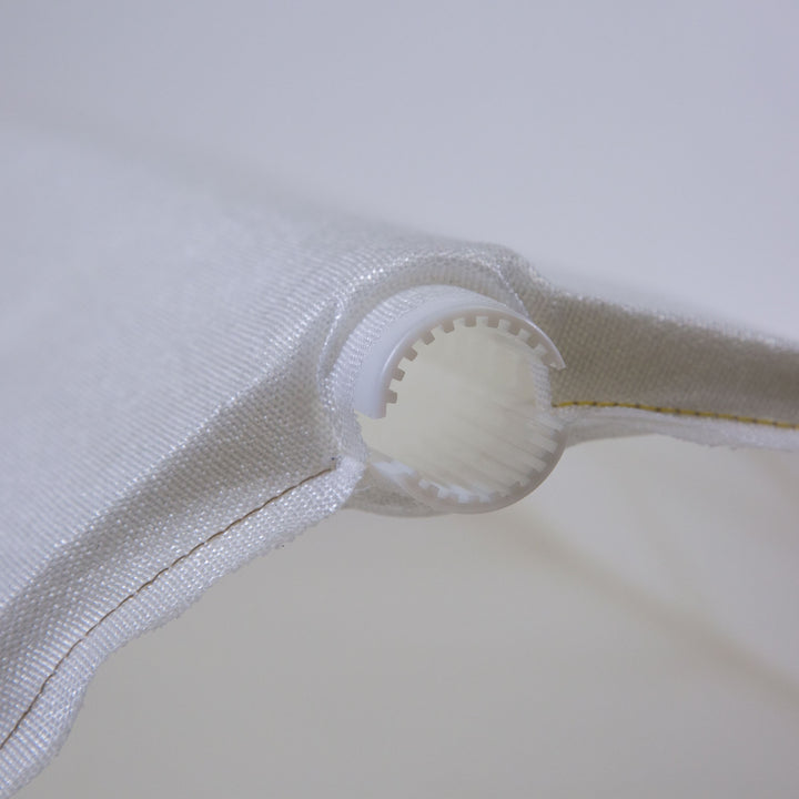 Close-up of white fabric and plastic frame showing part of a 24 inch replacement DE filter grid for pool and spa systems