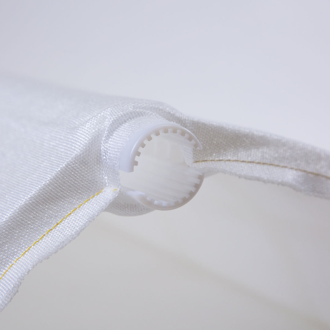 Close-up of a white fabric pool filter grid with yellow stitching and a white plastic end cap featuring internal ridges