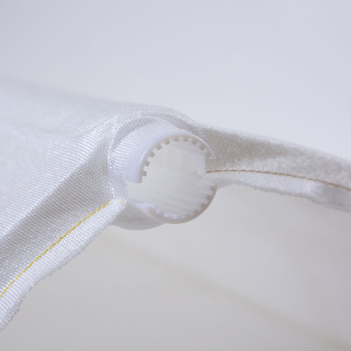 Close-up of a white fabric pool filter grid with yellow stitching and a white plastic end cap featuring internal ridges