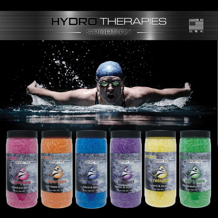 six HydroTherapies Sport Rx 19oz bottles with different colored crystals in pink, orange, blue, purple, yellow, and green shown below a swimmer in a cap and goggles