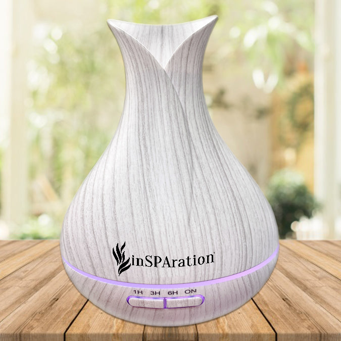 Insparation Inc aromatherapy diffuser with light wood grain finish shaped like a tulip bud with button timer controls and soft purple LED ring