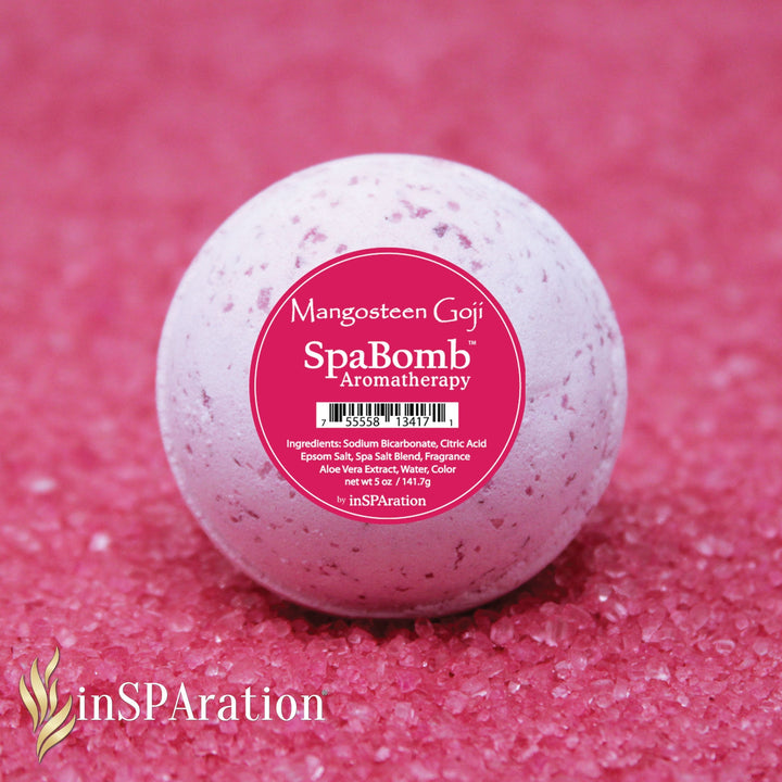 inSPAration SpaBomb Aromatherapy bath bomb with pink speckled surface and round shape on pink salt crystals background