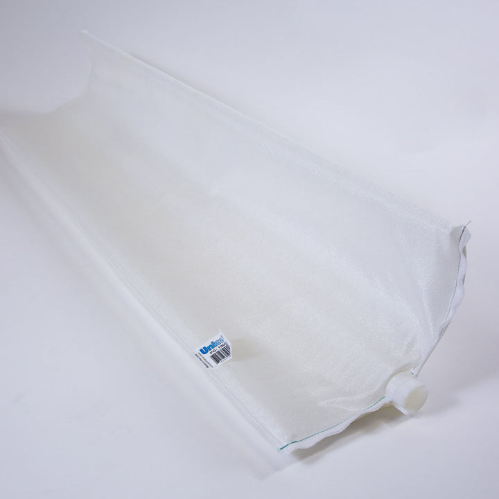 White elongated pool filter grid made of fine mesh fabric with a small tag and plastic connector at one end