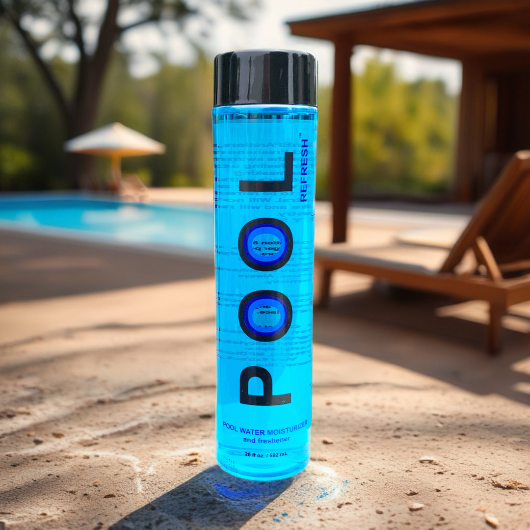 Tall transparent blue plastic bottle of Pool Refresh pool water moisturizer and freshener with black cap outdoors by poolside on textured surface