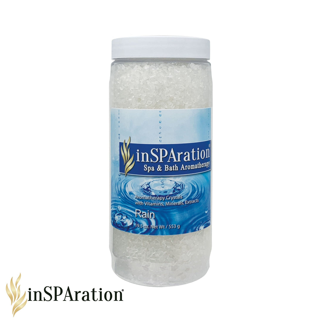 Clear plastic jar of InSPAration aromatherapy crystals with blue label showing water ripple design and white plastic lid