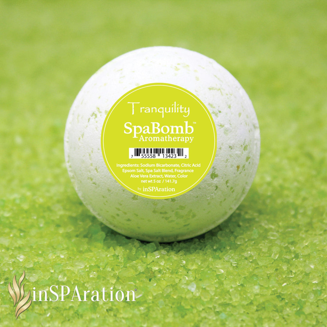 inSPAration SpaBomb Aromatherapy in white with green speckles resting on green spa salt crystals with circular green label