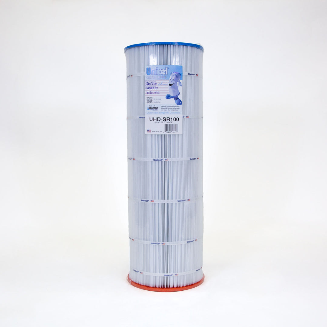 Tall cylindrical pool filter cartridge with pleated white material, blue top edge, and orange bottom edge with a label