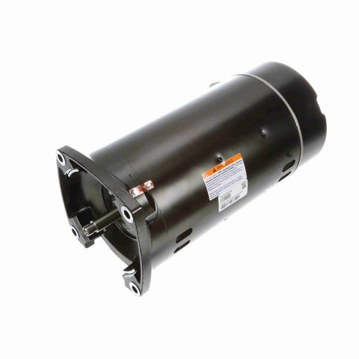 black cylindrical electric motor with mounting flange and warning label on the side isolated on white background