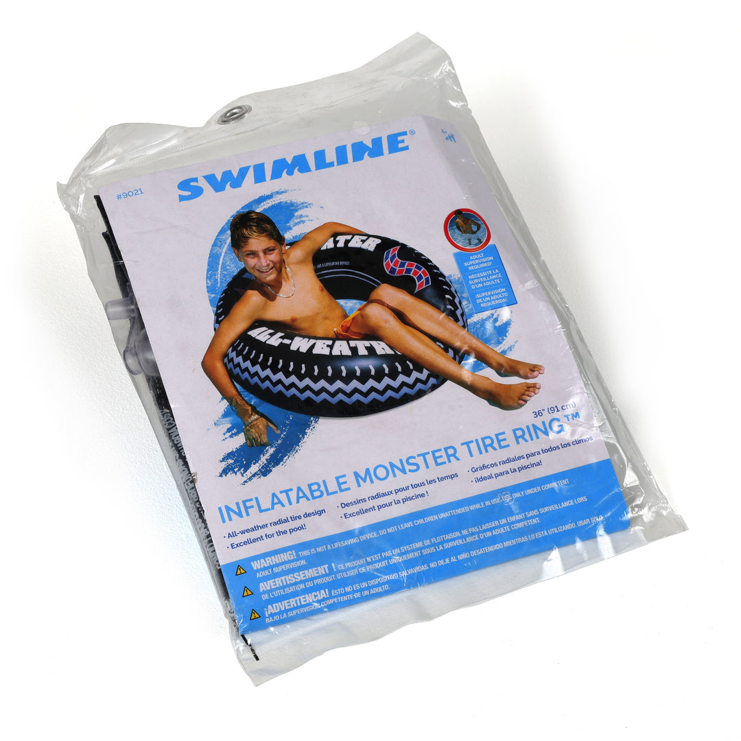Swimline 36 inch printed monster tire ring pool float in packaging showing boy lounging on a black inflatable tire with white and red all-weather radial tire design