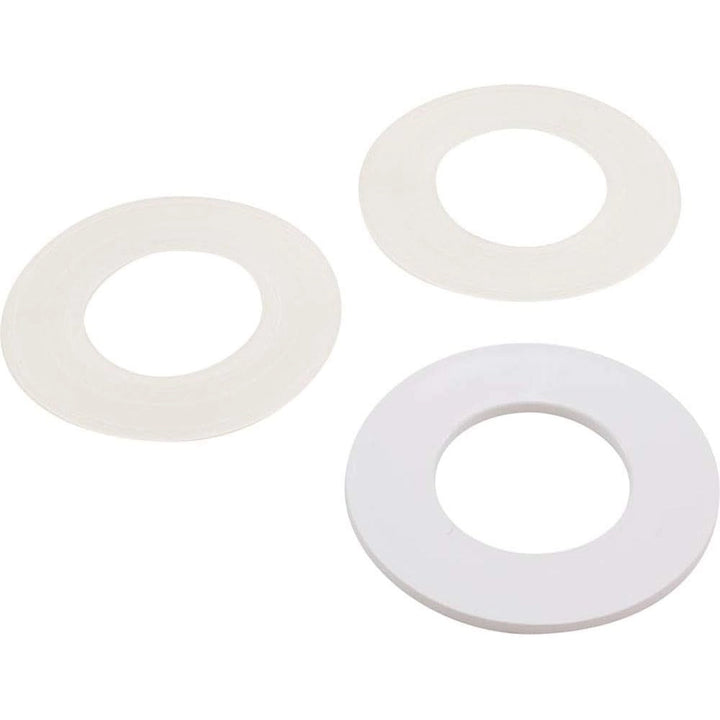 three round white plastic or rubber washer-like rings of different sizes arranged on a white background
