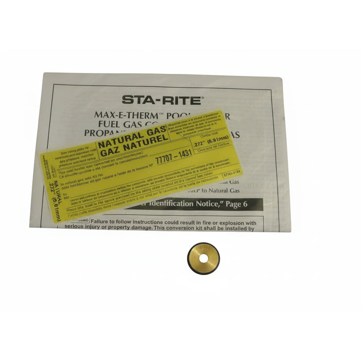 small brass disc part with rubber ring placed below printed instructional sheet with yellow label marked natural gas conversion kit