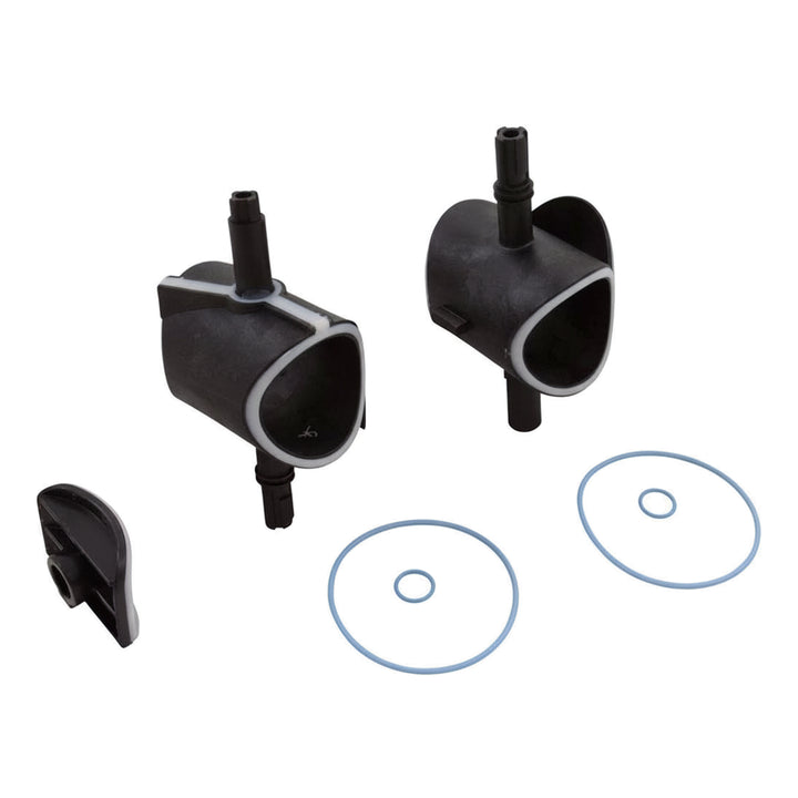 Two black valve components with white lining, a small black plastic piece, and two blue rubber O-rings laid out on a white background