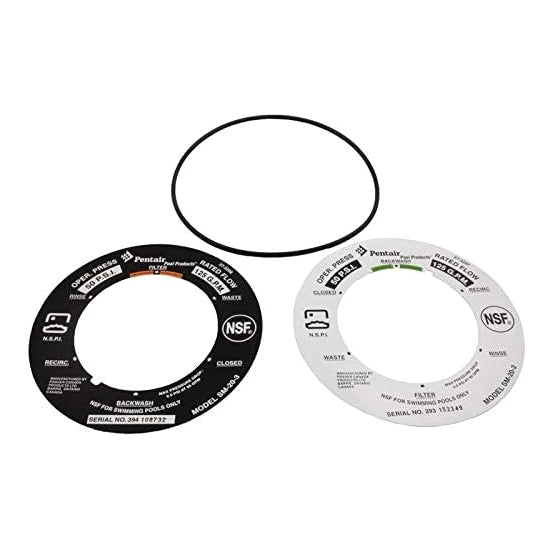 two circular valve faceplates with printed instructions and labels along with a black rubber O-ring gasket