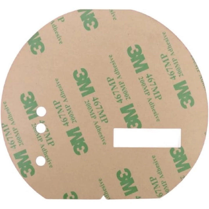 Round adhesive label with three small circular holes and one rectangular cutout with 3M branding in green on a brown background