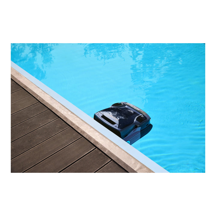 Black Aiper Scuba X1 Pro Max robotic pool cleaner resting against pool edge, partially submerged in blue water.