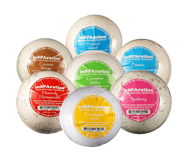 inSPAration SpaBomb Aromatherapy set showing seven bath bombs with colorful round labels in red, yellow, green, blue, pink, and brown with different scent names