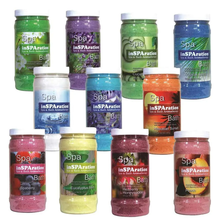collection of inSPAration spa bath aromatherapy crystals in clear jars with white lids showing various colors and scents like jasmine green and lavender purple
